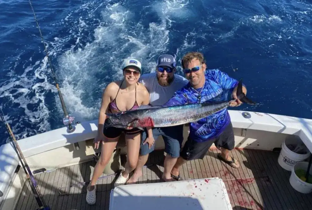 Sailfish jumping beside an offshore fishing charter boat in winter Gulf Stream water off Pompano Beach
