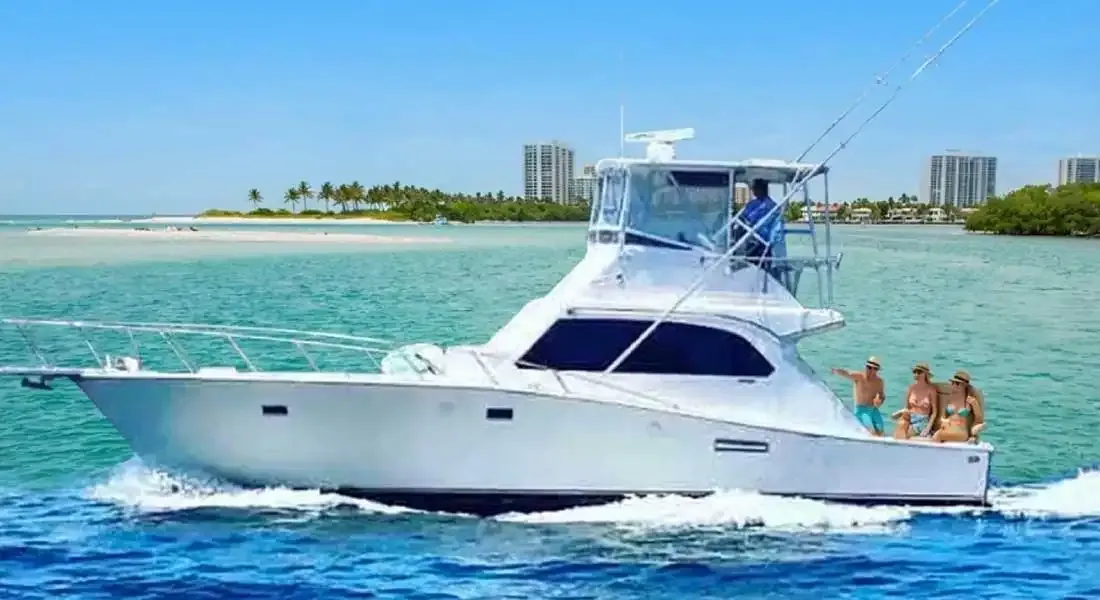 Small group of friends relaxing on the deck of a private charter boat near Pompano Beach