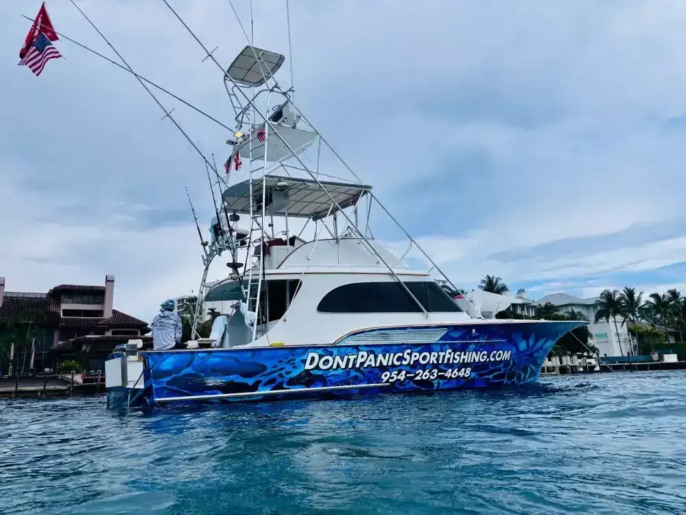 Sportfishing charter boat leaving Hillsboro Inlet at sunrise near Pompano Beach