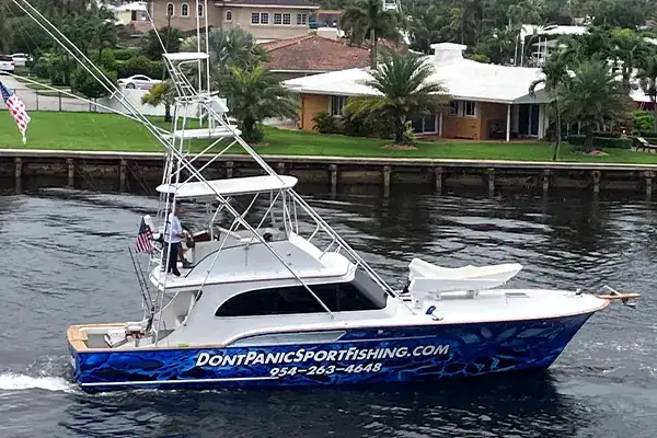 Private charter boat with a small group on the bow leaving Hillsboro Inlet in Pompano Beach