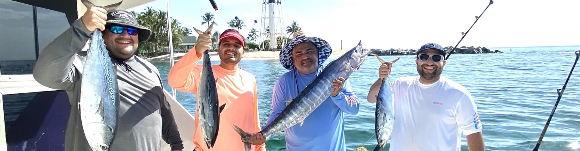 Guests holding their catch aboard Don't Panic off Pompano Beach